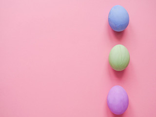 Fototapeta na wymiar Flat lay composition of Happy Easter holiday concept. Colorful pastel egg on pink background. Copyspace, top view.