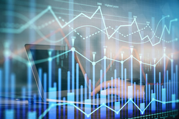 Double exposure of stock market graph with man working on laptop on background. Concept of financial analysis.