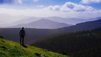 Naklejka na ściany i meble Man hiker on a top of a mountain , Aiako Harriak natural park, Euskadi