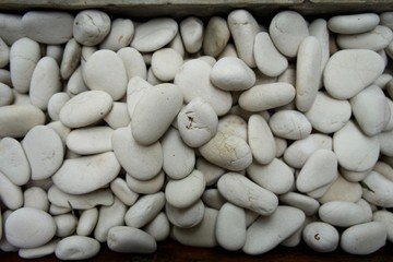 The full frame image of Sea Ivory White Pebbles, Photographed at close range, outdoor, suitable for wallpaper and background.