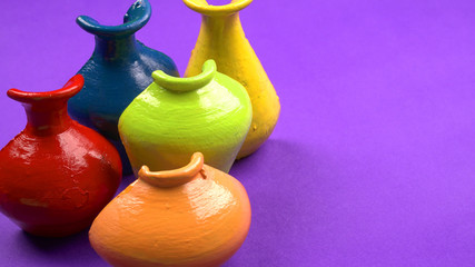 Beautiful empty decorative ceramic pots in warm happy colors on colorful background.
