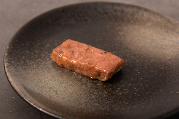 Homemade steak on a black plate