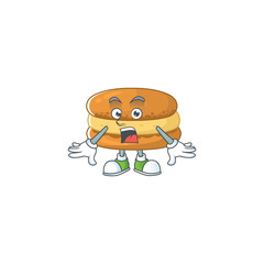 A mascot design of chocolate macarons making a surprised gesture