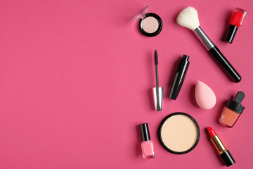 Obraz na płótnie Canvas Makeup decorative cosmetics and tools on pink background. Flat lay, top view, copy space. Beauty and fashion concept.