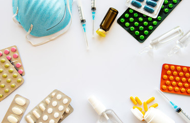 Blue medical mask and medicine pills