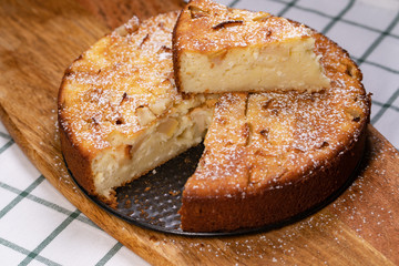 cut off part homemade cake pan on wooden Board. 
