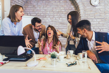 Angry emotional young people shouting on each other during solving problems of collaboration on common project.