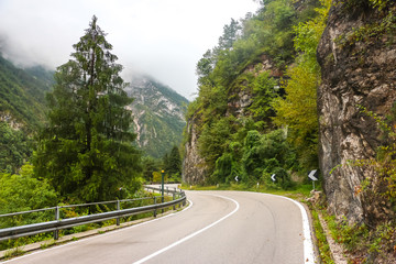 Mountain road in Belluno province. Cloudy day in italian mountains.