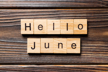 Hello June word written on wood block. Hello June text on table, concept