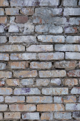 Old and traditionally masonry wall made of cement and bricks in various colors and shades.