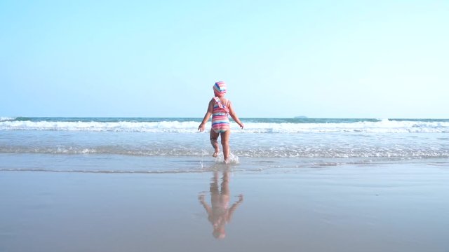 Asian little girl running on the beach
