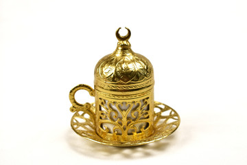 Fototapeta na wymiar gold Turkish coffee Cup isolated on white background