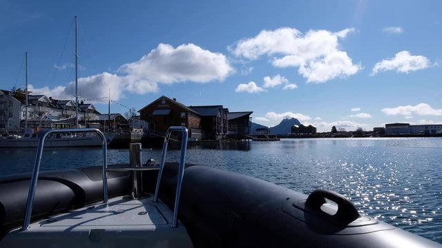 POV shot RIB boat at harbor of fishing village, Lofoten Islands, Norway