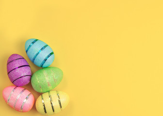 Easter decorated eggs on yellow background. Minimal easter concept.