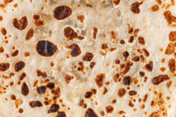 The texture of thin fried pancakes. Russian kitchen. Close-up.