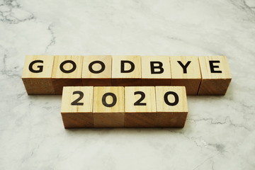 Goodbye 2020 alphabet letters on marble background