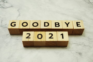 Goodbye 2021 alphabet letters on marble background