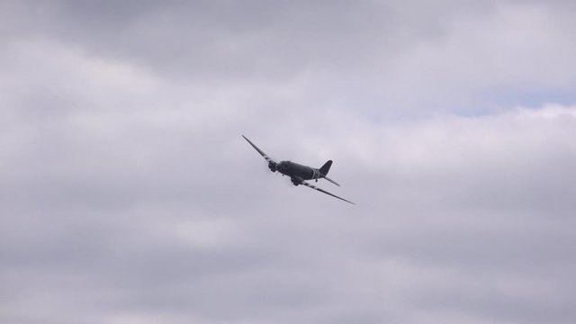 WW2 transport plane DC 3 flying low in blue sky UK 4K