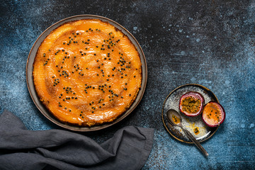 Top view of fresh baked mango upside down cake with passion fruit and caramel. Homemade sweet food concept. 