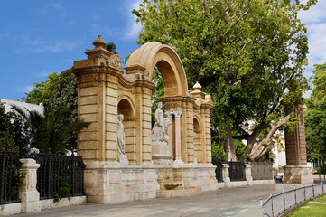 Obraz premium Maria Luisa's Palace with an arch and fountain. Seville, Spain. Architectural details, stone facade.