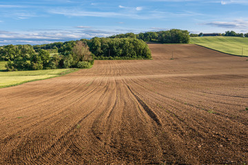 Fototapeta na wymiar Ploughed fallow farmland in France
