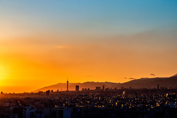 Naklejka premium Beautiful sunset over Tehran skyline with Milad tower in the Frame and amazing colorful sky.