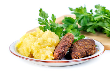 meatballs with mashed potatoes and parsley on a white background