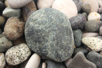 Fototapeta na wymiar sea ​​pebbles and round large stone
