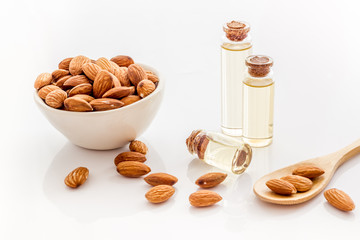 Healthy nutrition. Almond oil in small bottles on white background