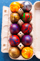 Handmade painted Easter eggs in egg box