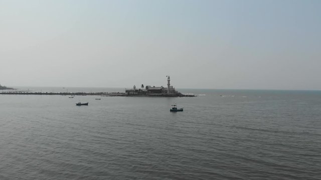 Rising drone shot of Haji Ali dargah sea mosque