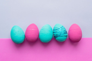 Colorful Easter eggs on a colored background. Concept of a religious holiday.