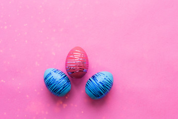 Colorful Easter eggs on a colored background. Concept of a religious holiday.