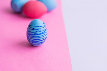Blue Easter egg on a pink background.