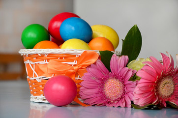  painted easter eggs in a basket and flowers