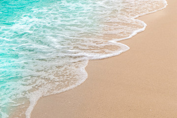 Soft wave of blue sea and sand on summer holidays beautiful beach, Background, Travel concept, Selective focus.