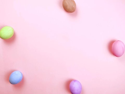 Happy Easter holiday concept stop motion animation. Colorful egg frame, pink background. Space for creative and design, copyspace, top view