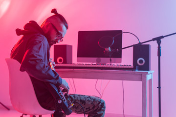 Musician and making music concept - Male sound producer working in recording studio.