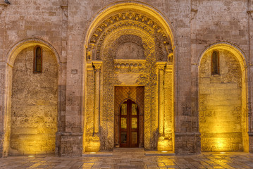 The entrance portal of the San Giovanni Battista church in Matera, Italy, at night