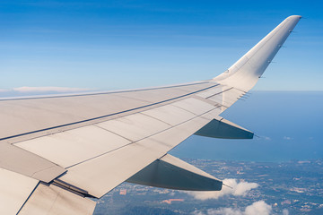 Aerial view wing of airplane from window seat.