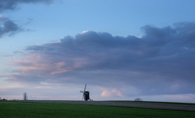 Obraz na płótnie Canvas Horebeke East Flanders Belgium. Sunset at field with windmill