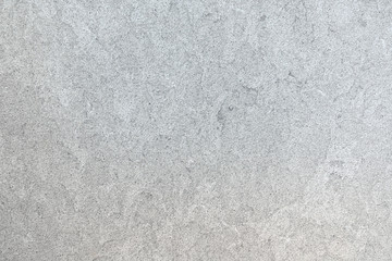 Marmoriertes Muster einer glatten hellgrauen Steinplatte in Nahaufnahme