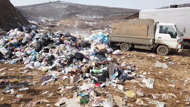 unloading garbage from a truck. A huge dump of household waste. looped video.