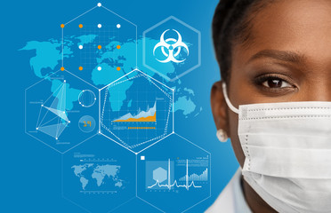 health, medicine and pandemic concept - african american female doctor wearing protective medical mask over world map with charts and biohazard symbol on blue background