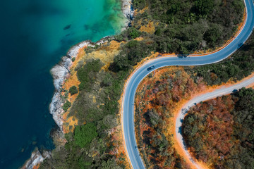 Aerial top down view of the asphalt road on the tropical coastline on Phuket island in Thailand
