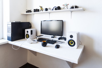The workplace of a professional gamer with a monitor, gamepad, headphones and an armchair. © Aboltin
