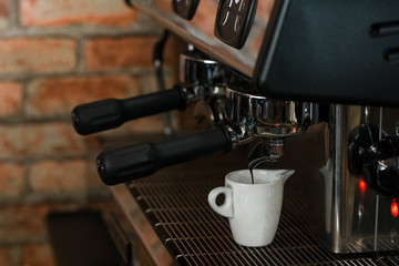 coffee machine pours a fresh batch of espresso