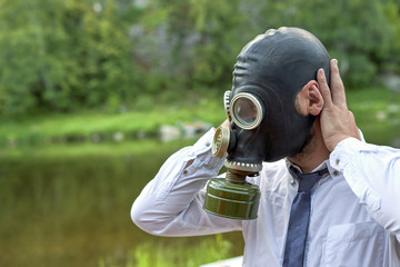 Head in the mask on the background of the river and the forest