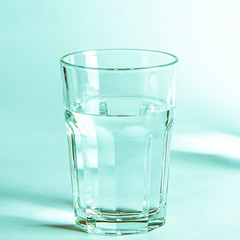 Pure clear water in a glass and jug stands on a white background