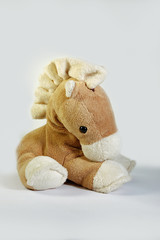 A beautiful pony mascot sitting alone and thoughtful. Waiting to hug him.